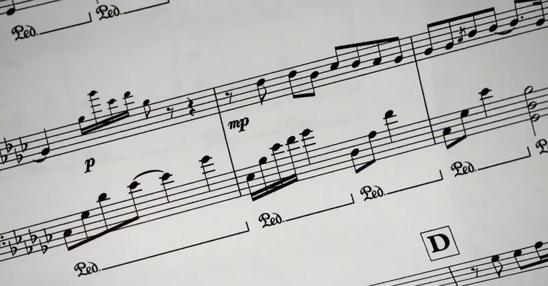 Close-up of a detailed musical sheet showcasing notes and symbols in black and white.