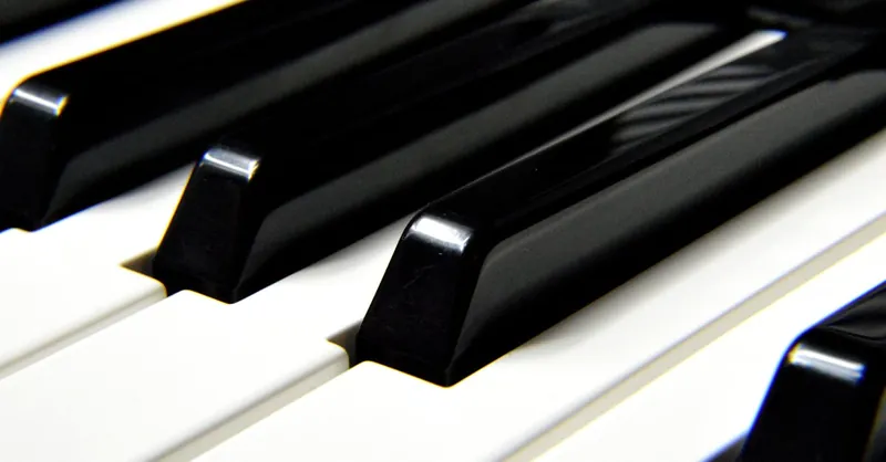 A detailed close-up shot focusing on black and white piano keys, highlighting musical harmony.