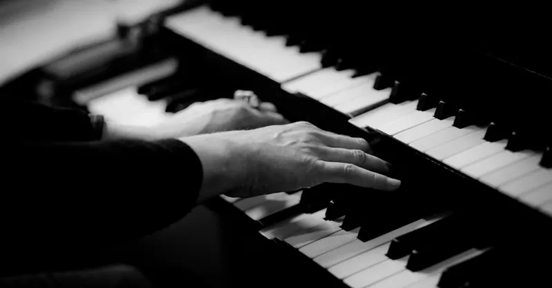 Close-up of hands playing piano keys, capturing the essence of musical creativity.