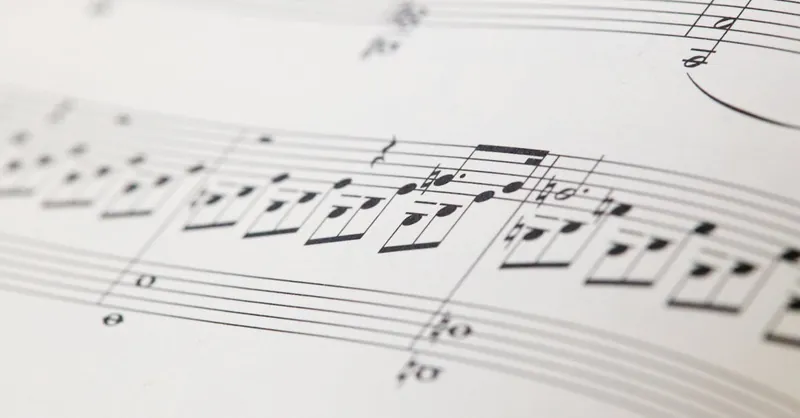 Detailed view of printed musical notes on a white sheet of paper.