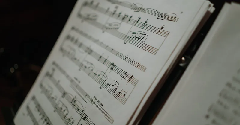 Close-up of sheet music displaying musical notes on a stand, perfect for musical compositions and practice.